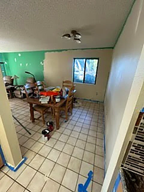 Room with masking tape and wall preparation in progress
